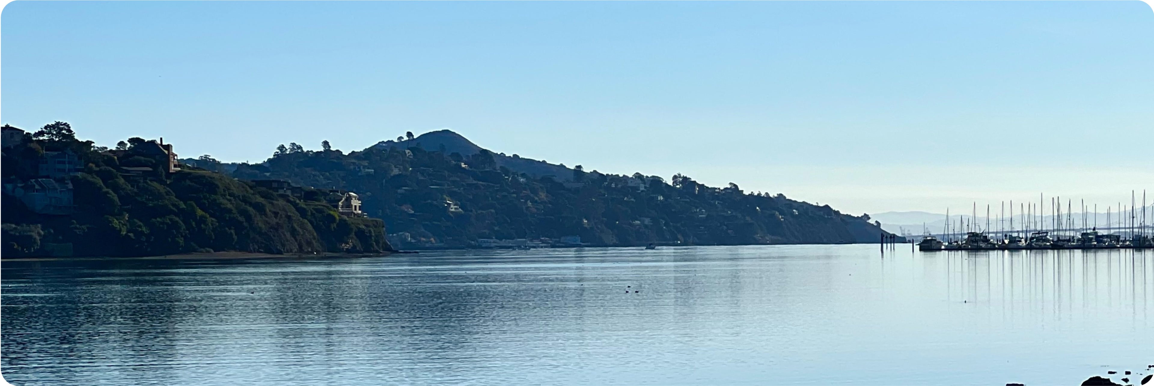A lake with hills in the background