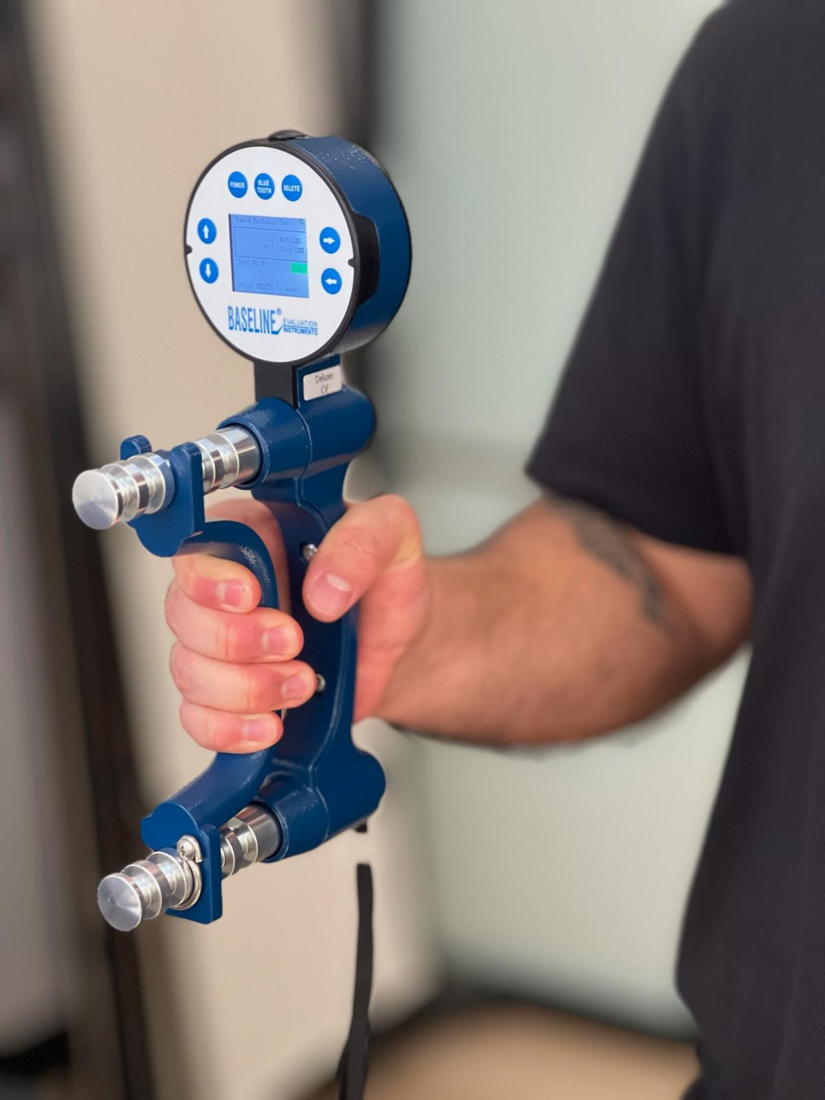 A man holding a grip strength measuring device
